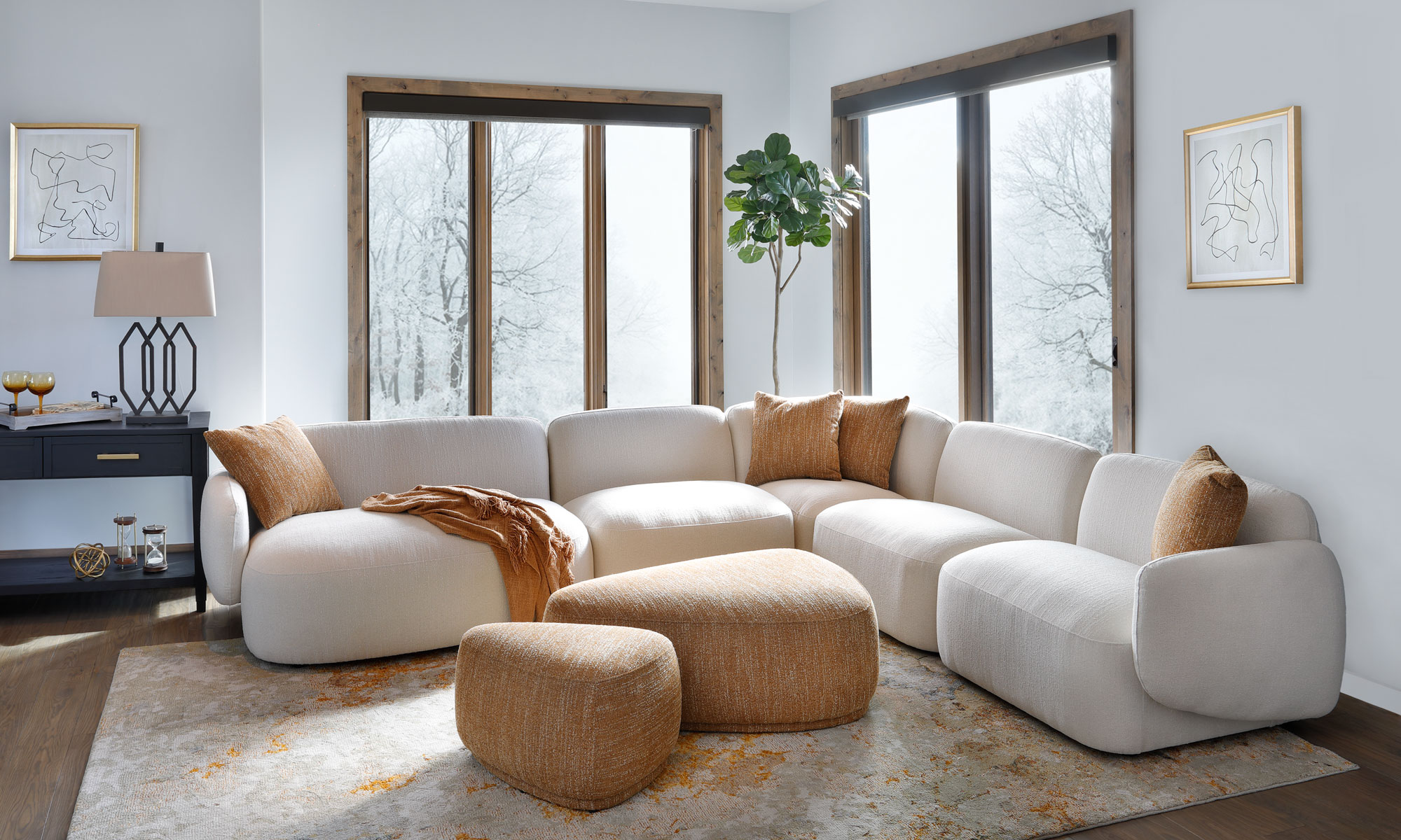 White curvy Sectional with Gold Accent Pillows and Ottomans