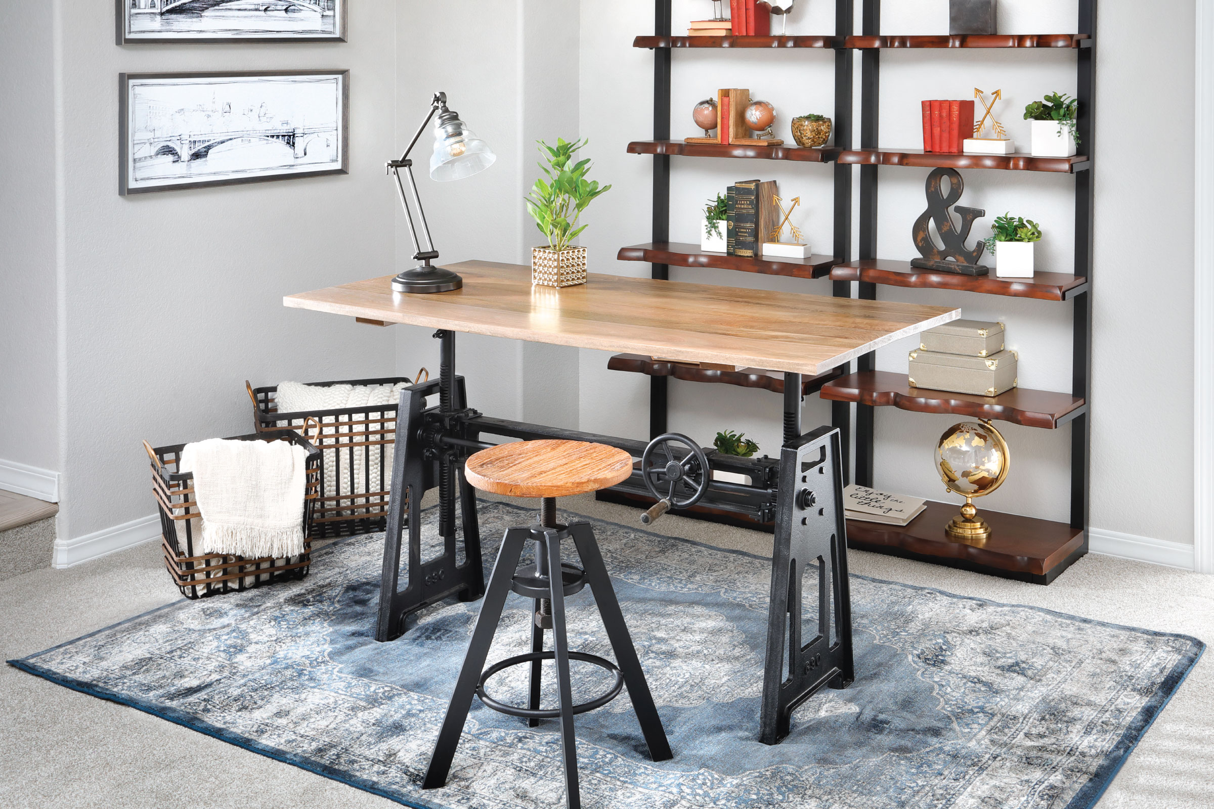 Crank Top table functioning as a desk with a metal bottomed stool that has a round wooden top. 