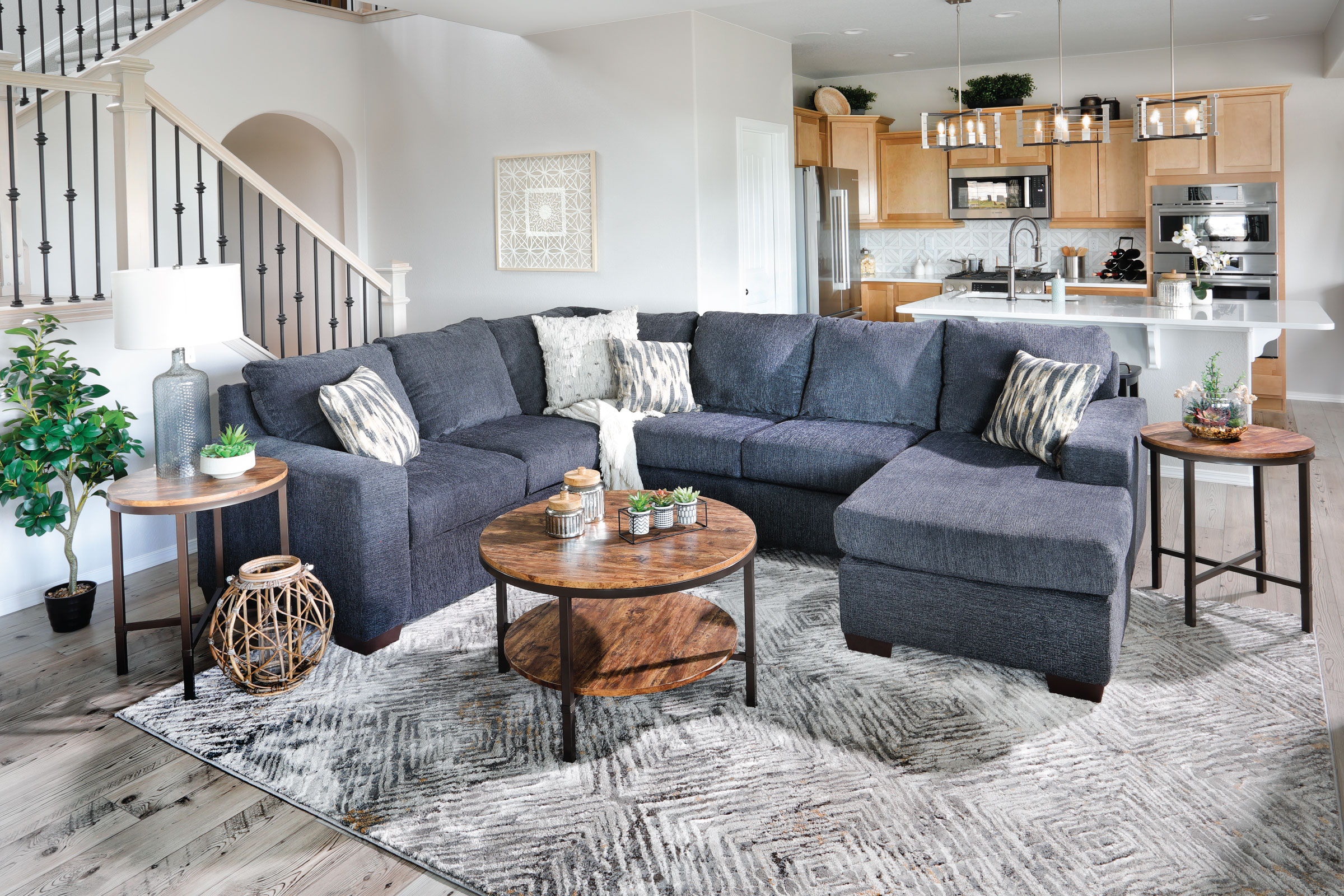 Gray Straight Lined sectional with Rustic organic wood decor around it.