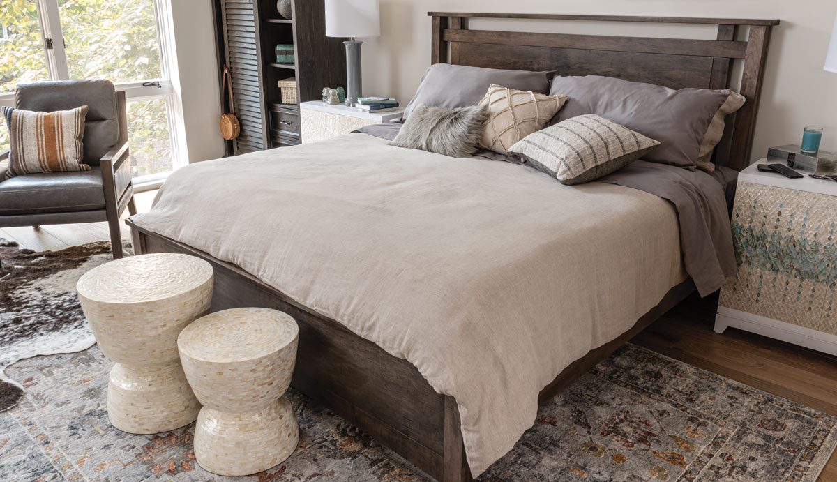 Grey Stained Wooden Bed frame with rectangular cutouts in headboard in a bedroom with organic textures and shapes