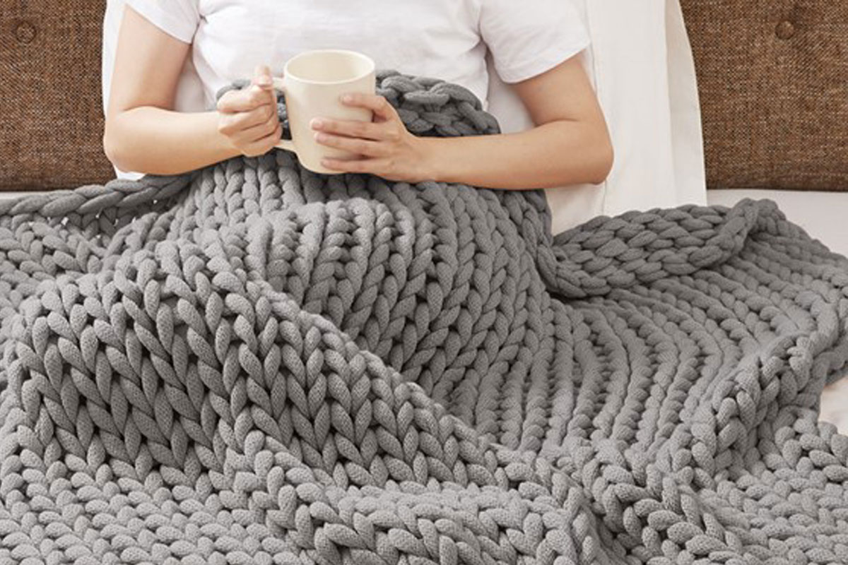 Curled up with double knit throw blanket drinking coco